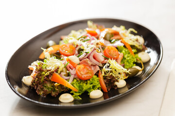 Fresh Vegetable Salad on black plate