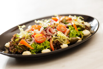 Fresh Vegetable Salad on black plate