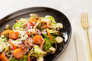 Fresh Vegetable Salad on black plate