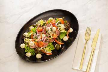 Fresh Vegetable Salad on black plate