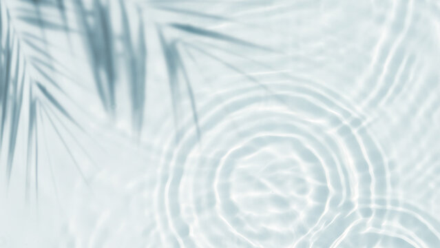 palm leaf shadow from above over transparent water surface with sunlight reflection topview, abstract background for travel, beach vacation and wellbeing