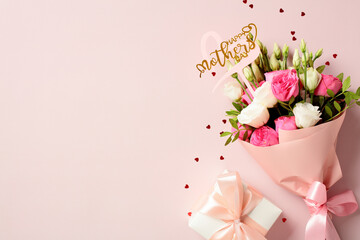 Gift box and bouquet of flowers on pink background. Happy Mothers Day concept.