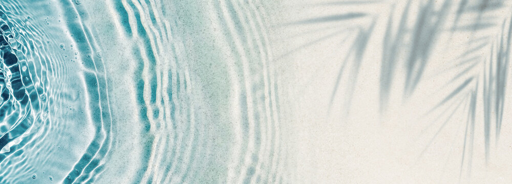 abstract empty sand beach with palm leaf shadow and transparent water wave from above, blank background banner for travel, vacation and wellbeing with copy space