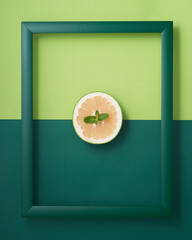 Pomelo with mint leaf in wooden picture frame