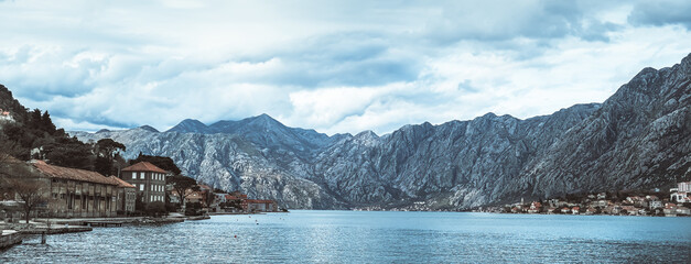 Panoramic landscape with old church in Kotor, Montenegro.Harbor and boats on a sunny day in Boka Kotorska bay, Montenegro, Europe.