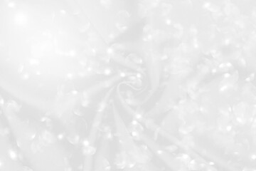 Abstract blurred bokeh on white fabric background, festive and luxury style background