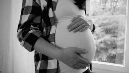 Blissful Pregnancy Scene, Joyful Expectant Woman Gently Touching Her 8-Month Pregnant Belly,...