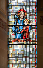 Saint Joseph with little Jesus. A stained-glass window in Église de la Sainte-Trinité (Holy Trinity Church) in Walferdange, Luxembourg.