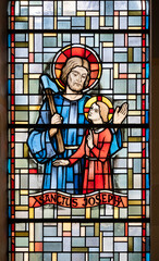 Saint Joseph with little Jesus. A stained-glass window in Église de la Sainte-Trinité (Holy Trinity Church) in Walferdange, Luxembourg.