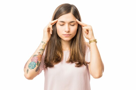 Young Woman Applying Gentle Pressure Temple Her Head White Background