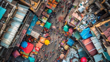 Overhead view of busy street market with vibrant umbrellas shading stalls and vendors selling various goods - obrazy, fototapety, plakaty