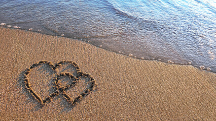 Two hearts drawn on brown sand of paradise beach - 786382817