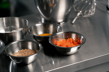 close-up in professional kitchen there are iron bowls with ingredients on an iron table