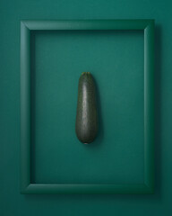 Zucchini in picture frame on green background