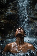 Meditative Pose Under Cascading Waterfall, The image features an individual in a meditative pose, enveloped by the powerful yet serene rush of a waterfall. 