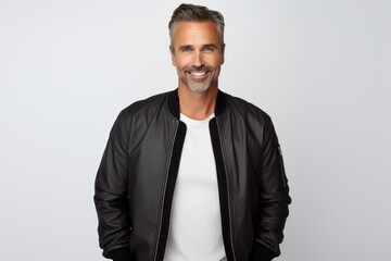 Portrait of a satisfied man in his 40s wearing a trendy bomber jacket isolated on white background