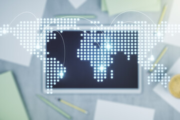 Abstract creative world map with connections and modern digital tablet on background, top view, international trading concept. Multiexposure