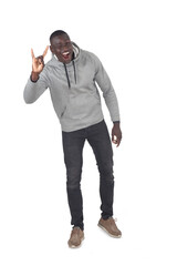front view of a man showing the horns sign with fingers, looking at camera on white background - 786402837