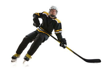 Dynamic image of competitive focused man, hockey player in motion during game, preparing for...