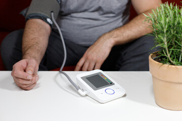 overweight man measuring blood pressure close-up