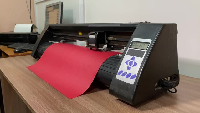 paper plotter. flatbed plotter.sheet of red paper.slow motion video. High-quality shooting in 4K format.