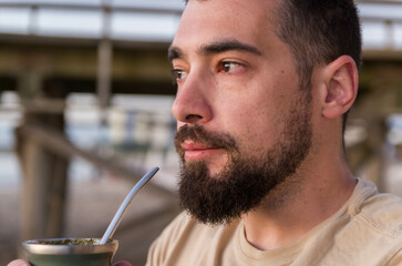 Man drinking chimarrão, mate (an infusion of yerba mate with hot water) at sunset - 786413809