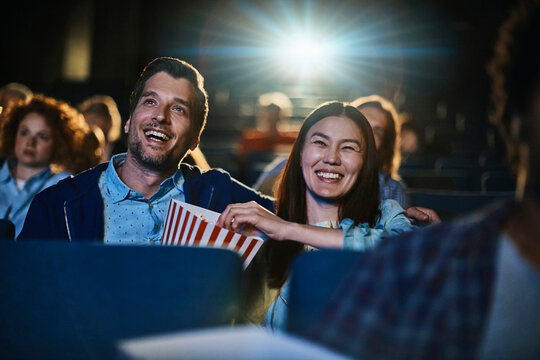 Young couple watching film in movie theater