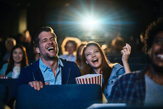 Young couple watching film in movie theater