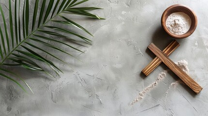 Tropical spa and wellness setting with palm leaves, natural bath salt in wooden bowl, and bamboo massage sticks on textured grey background. Relaxation and natural beauty. - obrazy, fototapety, plakaty