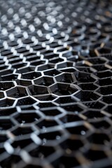 Macro shot of an intricate black honeycomb structure showcasing sophistication and industrial design