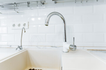 Plumbing fixture with tap, sink, and water filter for household water supply