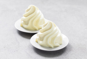 Vegan Lemon cream dessert, Panna Cotta in the form of French Chantilly cream. Light grey background. Close-up