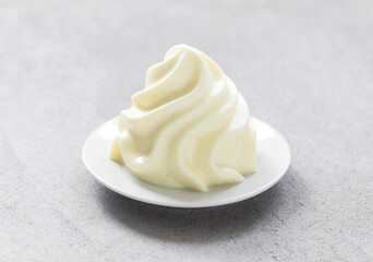 Lemon cream dessert in the form of French Chantilly cream. Light grey background. Close-up