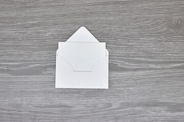white envelope with Blank paper  on wood - White paper sheet on a dark wooden texture 