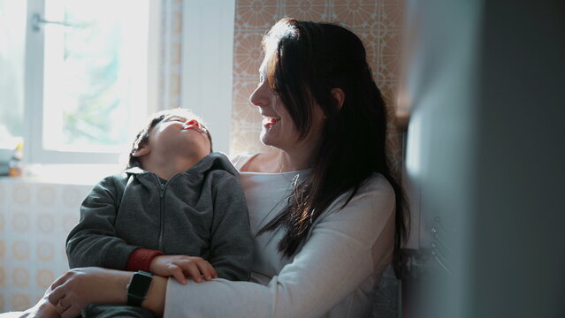 Mother and child in genuine interaction, real life laugh and smile between mom and son. Affectionate candid moment relationship