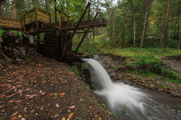 Old water mill on the river in the forest