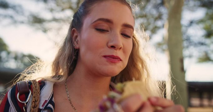 Hungry, eating and woman with taco for lunch, meal or snack outdoor on summer vacation in Mexico. Smile, happy and female person enjoying Mexican cuisine or food for dinner on holiday or weekend trip