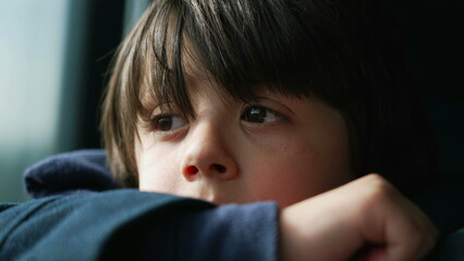 Pensive Child with Close-Up of Eyes and Face While Traveling by Train, Contemplative Gaze and...
