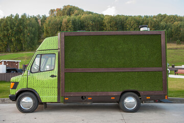 Small truck with green grass closeup photo.