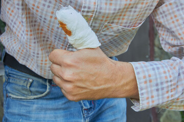 a man with a bandaged finger, male locksmith with an injured finger, Injured finger with bandag