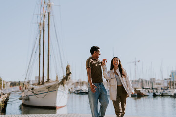 Fototapeta premium Serene stroll along Barcelona marina at with vintage sailing vessel