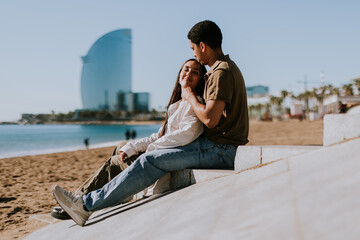 Serene Barcelona beach moment with couple embracing by the Mediterranean sea