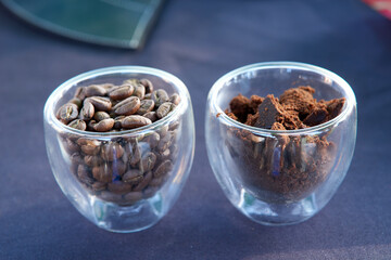 This image captures the journey of coffee from whole beans to grounds, presented side by side in two clear glass mugs