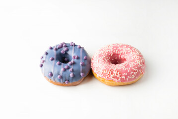 Donuts with pink and purple glaze on a white background.