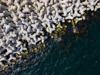 Aerial drone view of a breakwater. breakwater in the sea, a collection of concrete tetrapod breakers