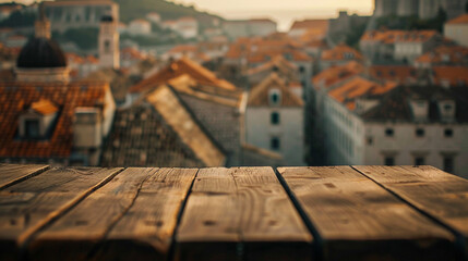 Atmospheric shot of a simple wooden table set against a dreamy blur of Dubrovnik's old town  merging past with present - obrazy, fototapety, plakaty
