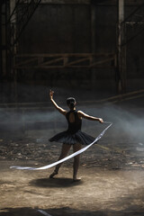 Young ballerina girl preforming ballet dance with ribbon