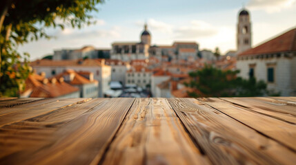 Tranquil dining perspective from a wooden table  with Dubrovnik's historic architecture softly blurred in the distance - obrazy, fototapety, plakaty