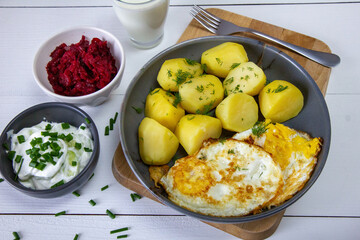 Potatoes with fried egg, buttermilk, beetroot and cucumber salad. Spring dinner - 786470628