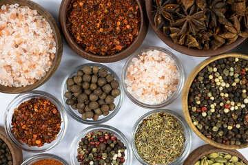 Assortment of oriental spices close-up on white background.